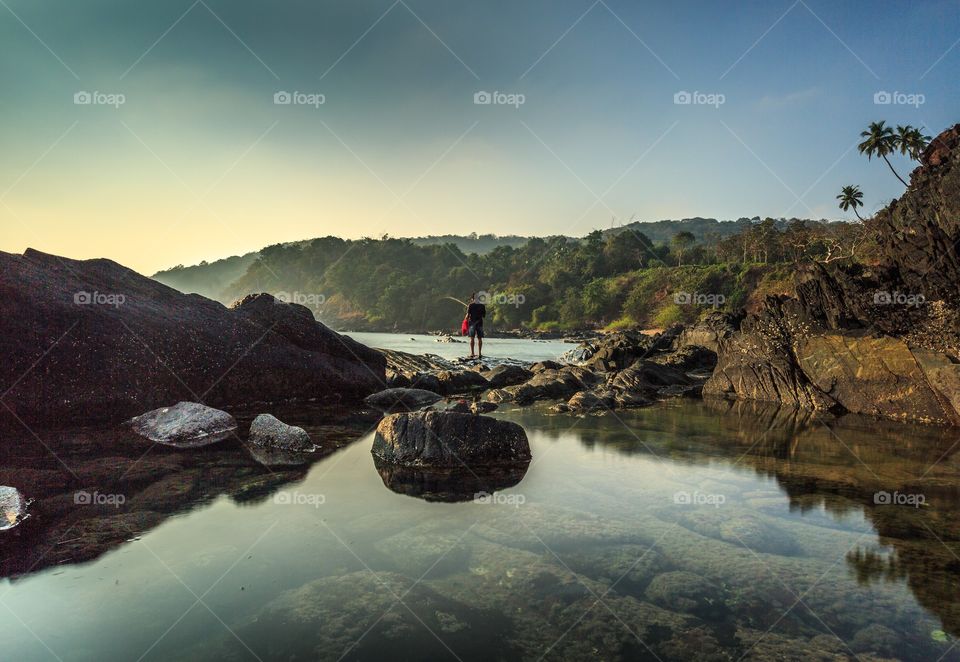 man fishing in solitude in a beautiful evening