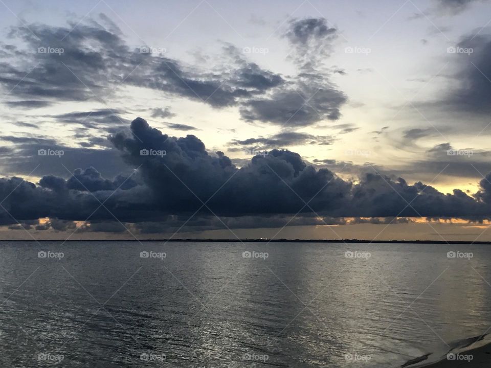 Clouds - Dark colored , puffy storm clouds float over the Choctawhatchee bay just begot the storm