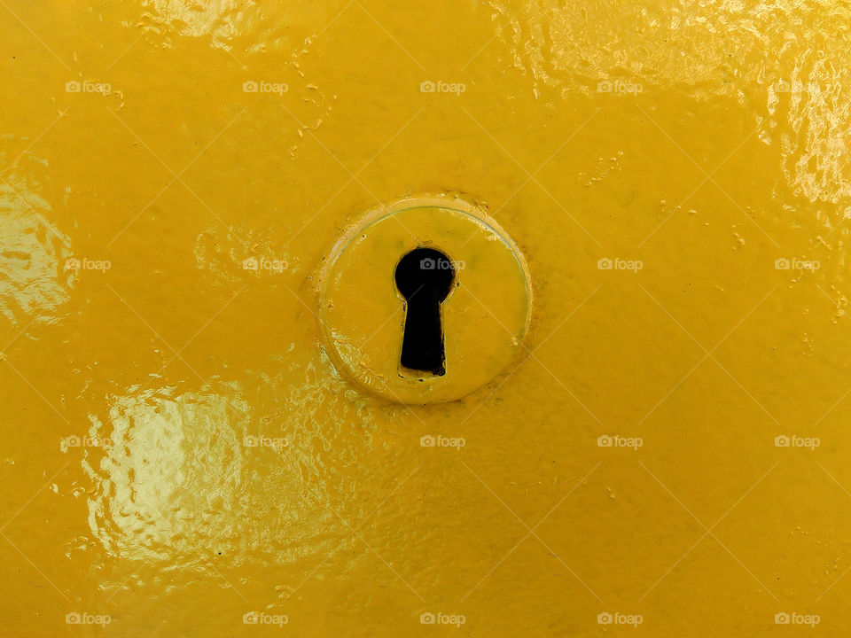 Yellow key hole from post office box...