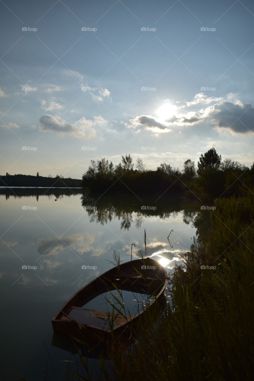 Sunken boat on the lakeside 