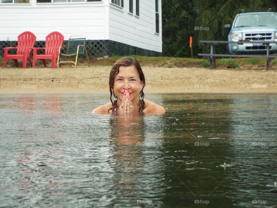 Swimming in the rain in front of cottages