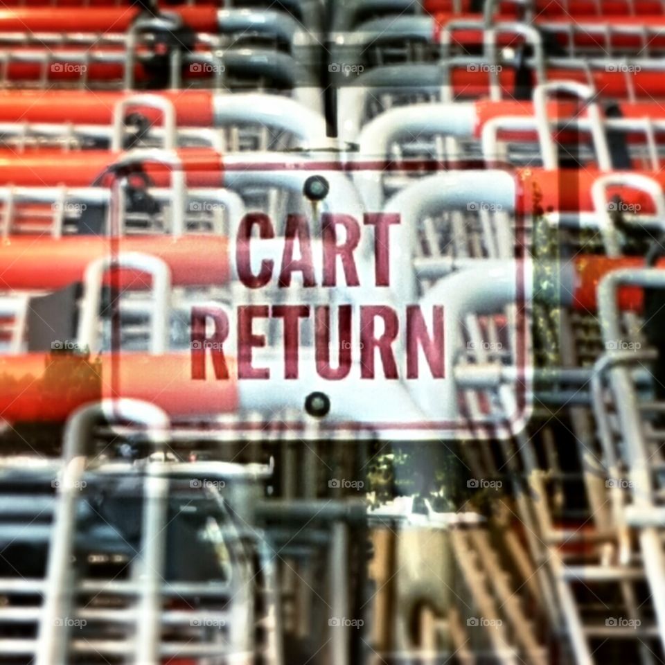 Shopping Cart Overlay Return Sign. rows of carts in the return area , overlayed with sign overhead.