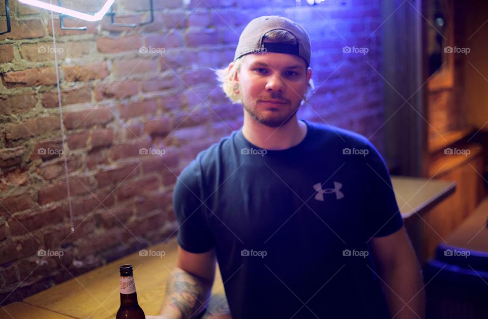 Handsome guy enjoying a drink at the bar