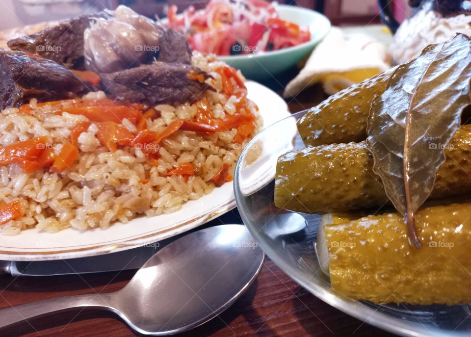 today for lunch we had pilaf with meat, salad with tomatoes, pickled cucumbers and flatbread, an Uzbek national dish.