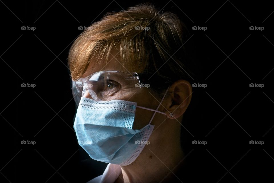 Woman wearing a face mask and protective eyeglasses 
