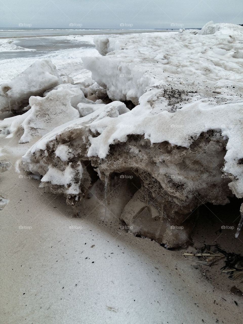 Beach in winter with ice clumps