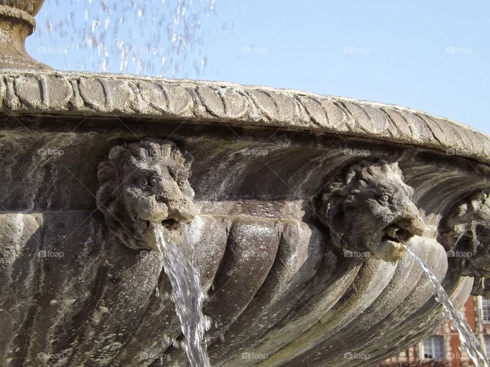 lion fountain. a stone fountain in france with lions that spit water