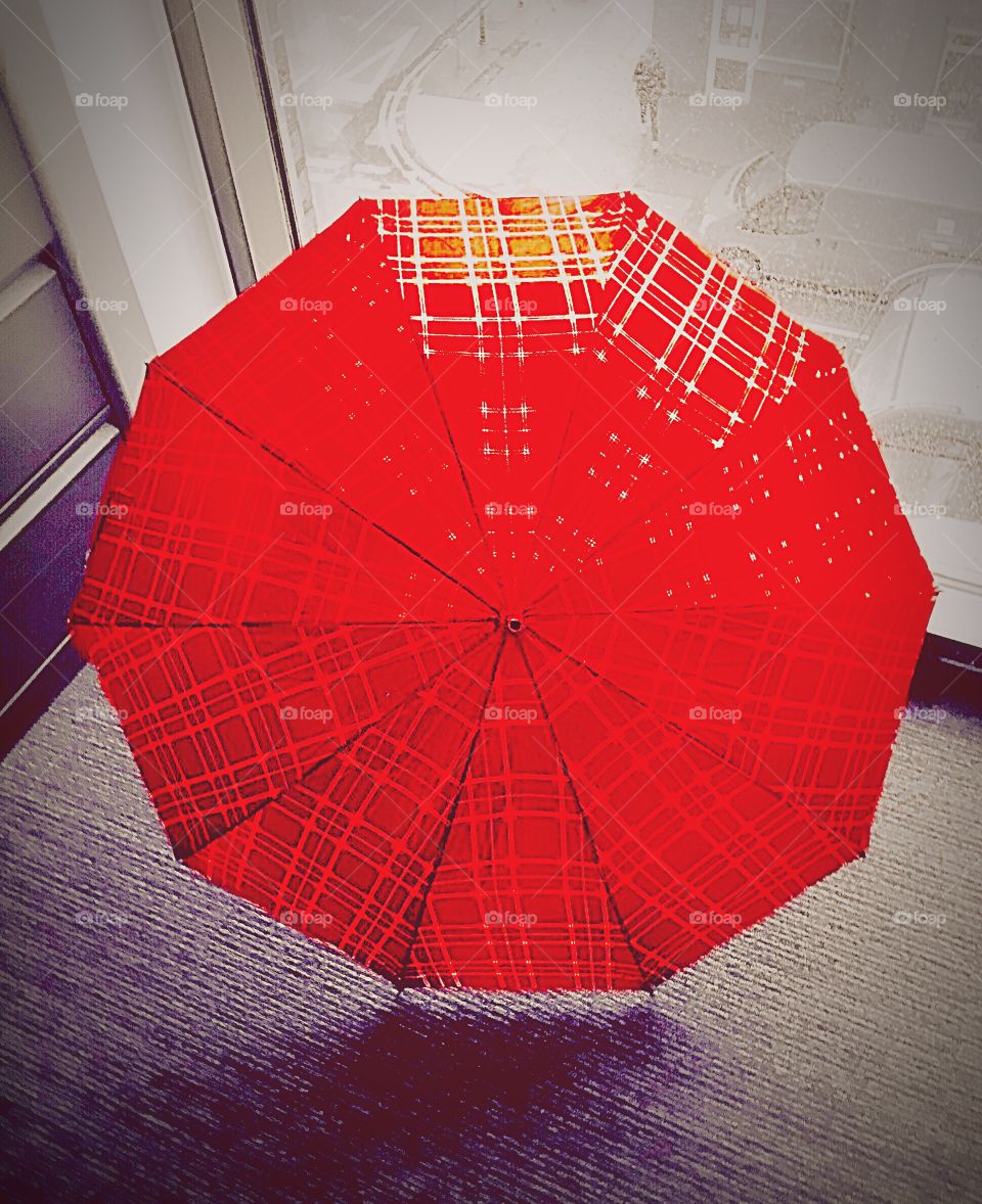 Red Umbrella . Drying off my umbrella in my office in front of my window, overlooking the grey rainy day in Manchester.