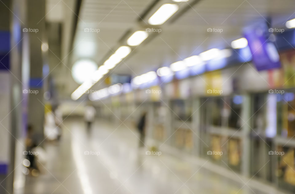 Blurry image of a passenger stand waiting for the subway