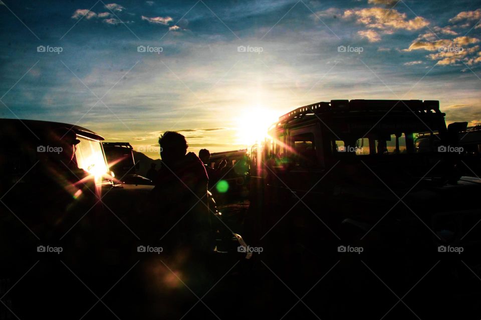 Sunrise that illuminates the car parking area on a hill in the Bromo mountains, East Java.