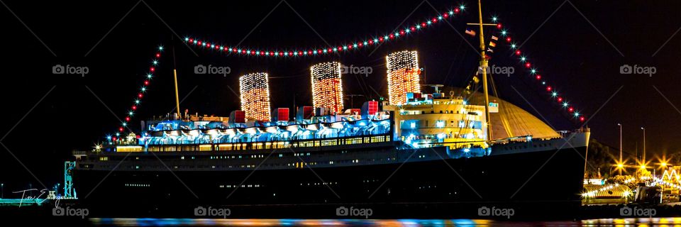 The HMS Queen Mary lights up the night in Long Beach, Los Angeles, California, USA. 