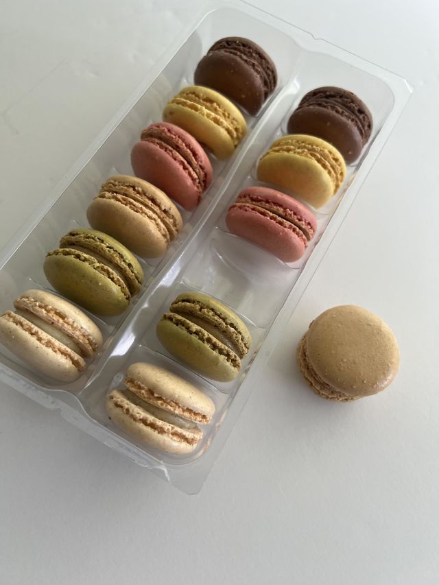 A plastic tray of Safeway Signature Reserve French Macarons 12 count in various flavors and colors. Crafted in France. Product of France.