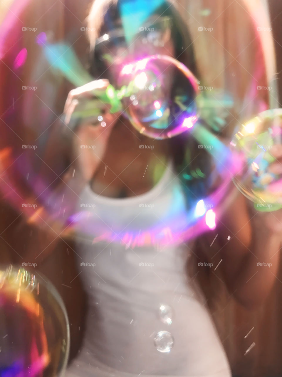 Young woman blowing soap bubbles 