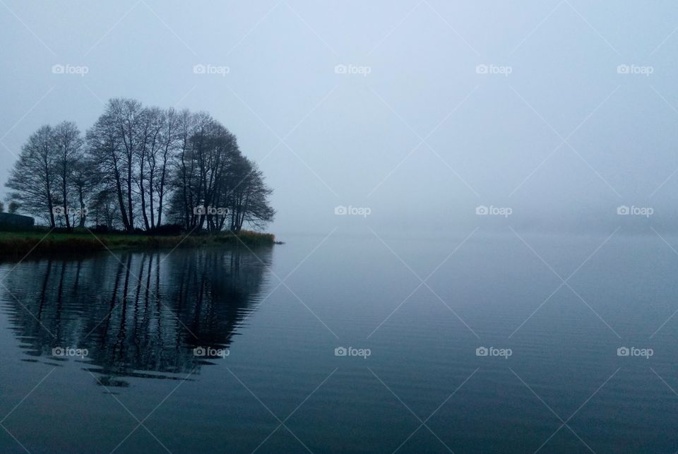 Scenic view of lake in foggy weather
