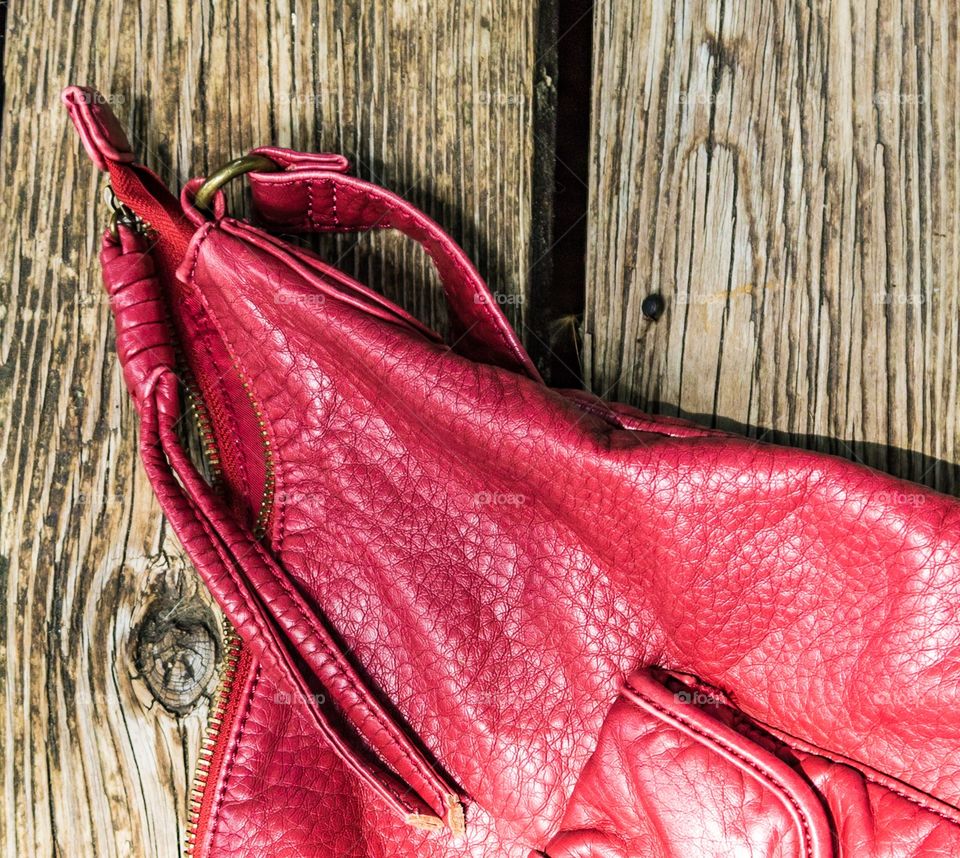 Textured red purse and wood