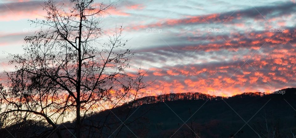 mountain silhouette on background of bright clouds