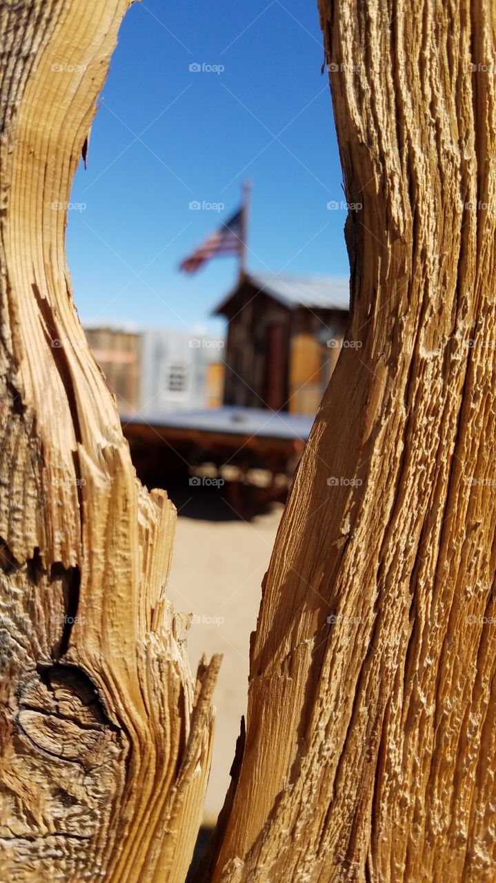 blurred American flag through fence