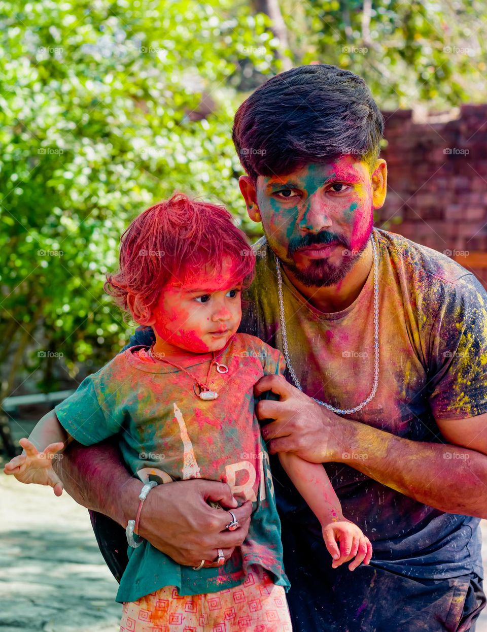 8-03-2023 jalalpur trivediganj barabanki uttar pradesh in India. little boy playing holi with his uncle