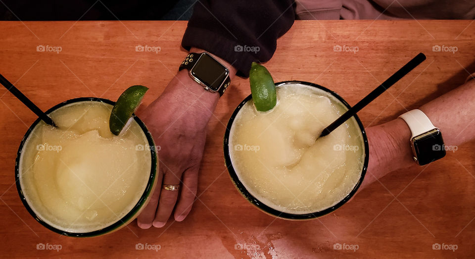 two smart watch people drinking margaritas.