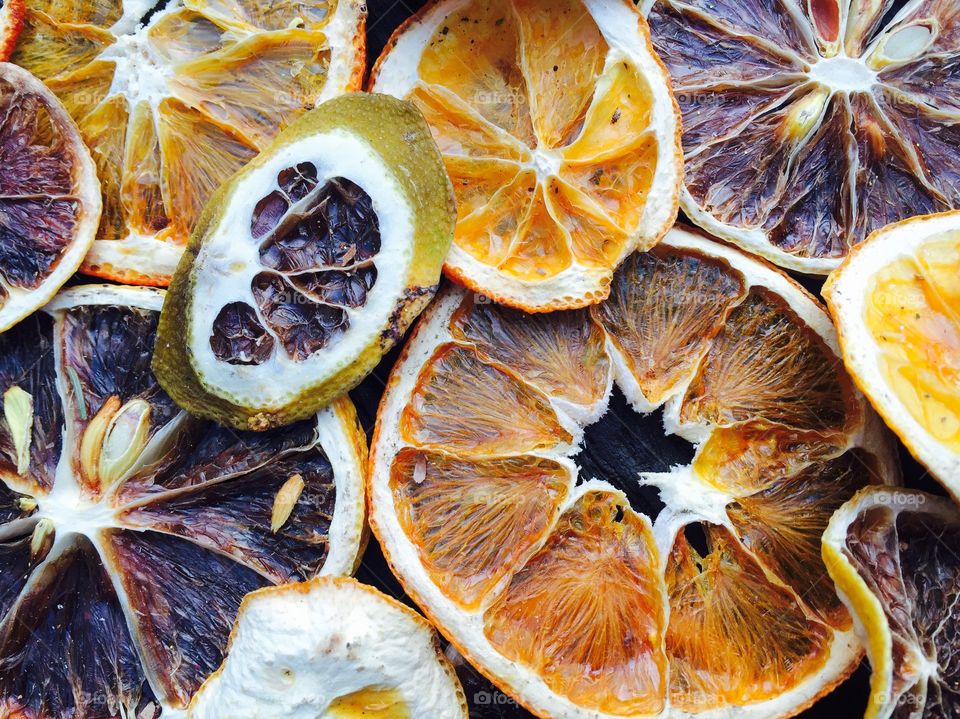 Slices of dried oranges on wooden table