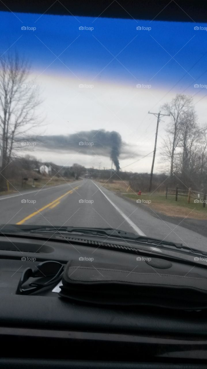 smoke rising. was going  down the road and how the smoke rising  seemed to connect  to  the  cloud