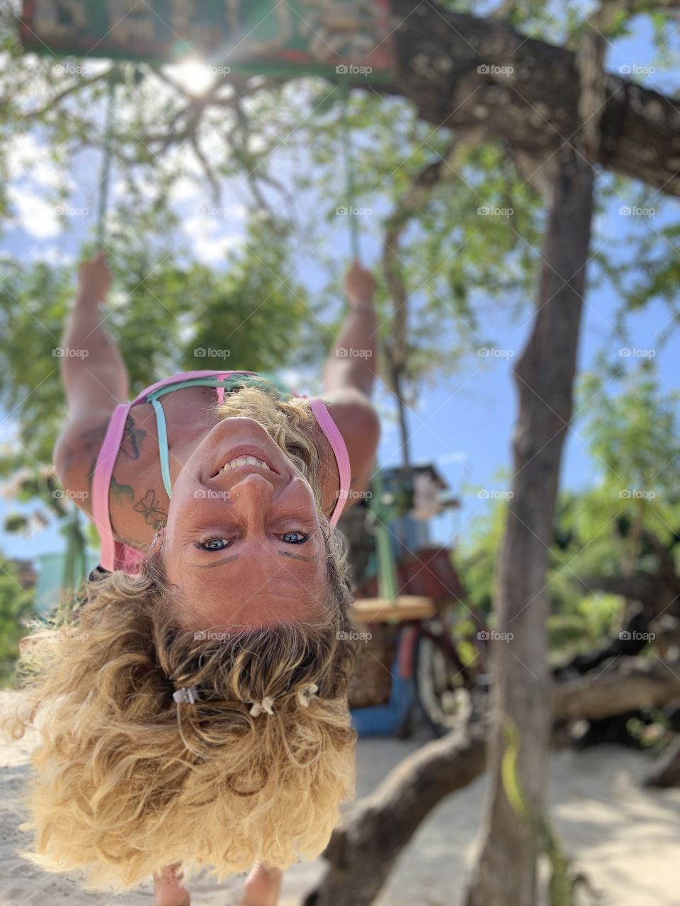 Happy Woman in the swing  under the tree 