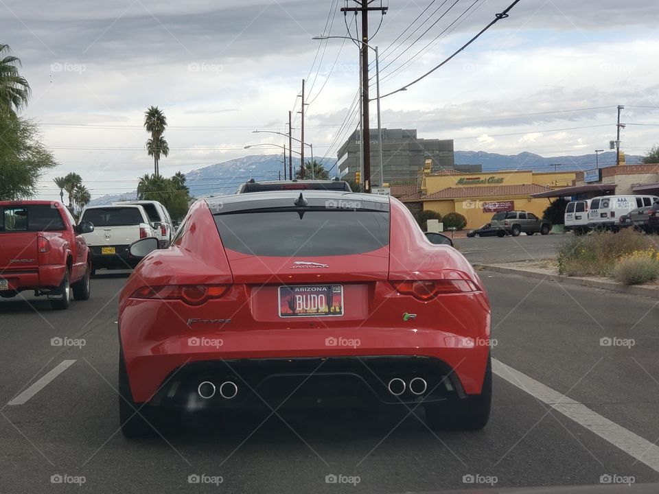 sportscar driving down the road