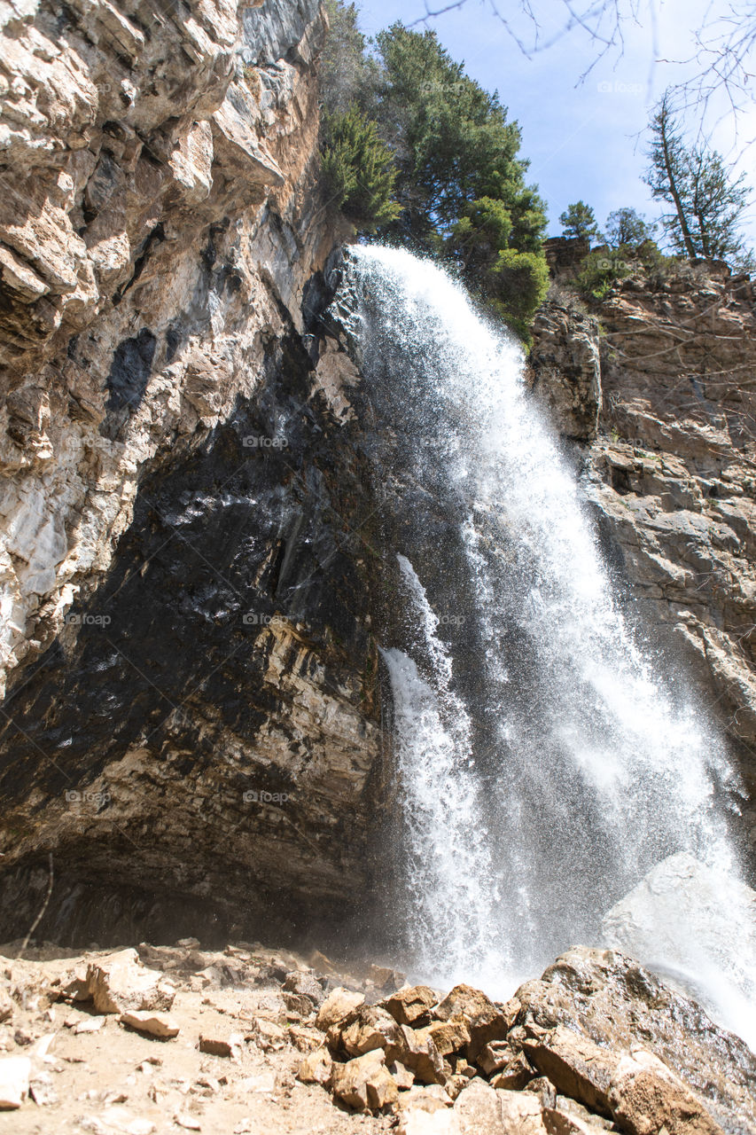 Beautiful, strong Colorado waterfall that comes flowing straight from the rocks rather than over a ledge. 