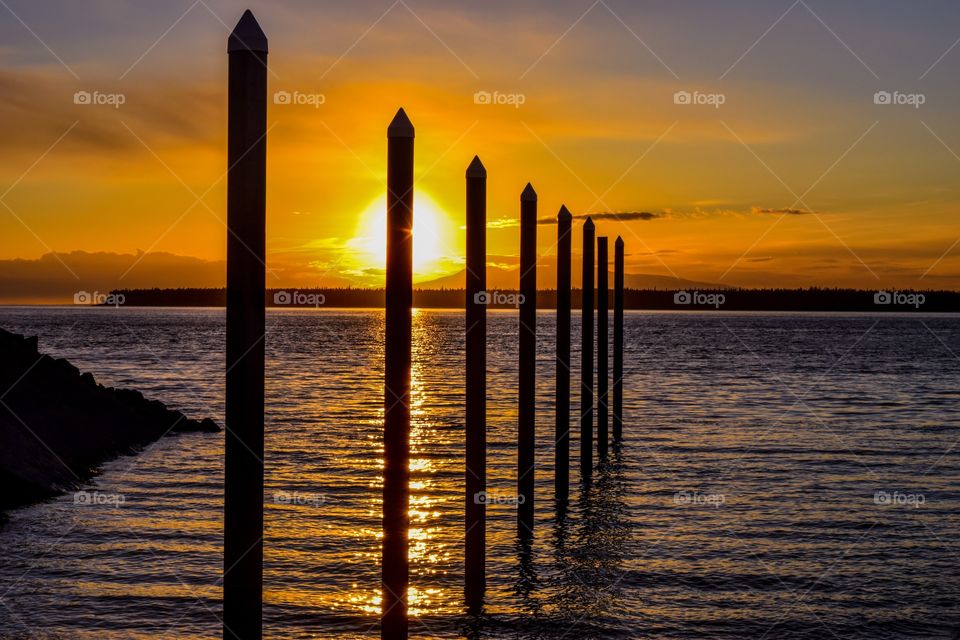 Sun setting over piers at a boat launch at the port of Anchorage, Alaska