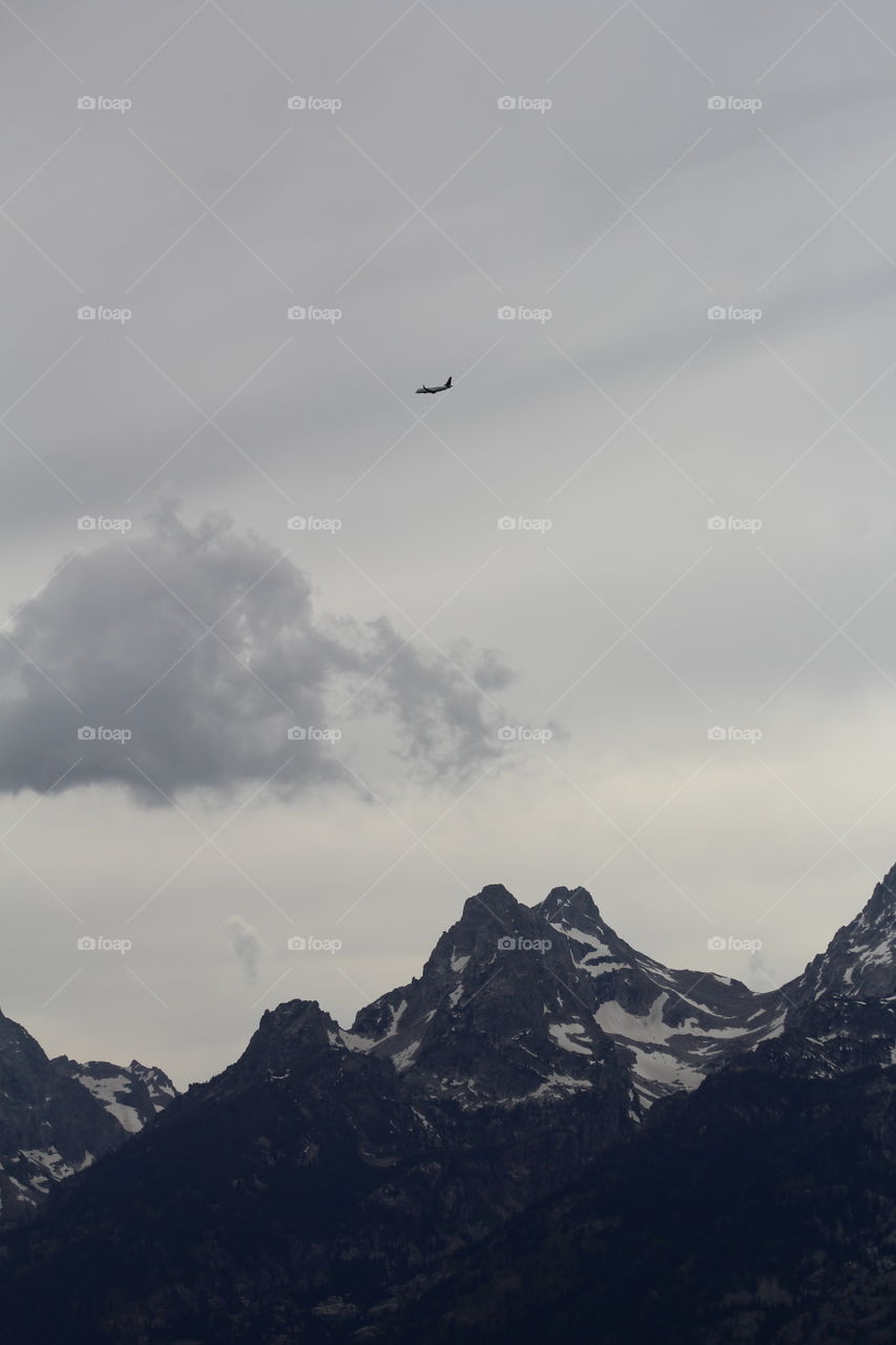 Mountain mountain top plane cloud snow outdoors wilderness