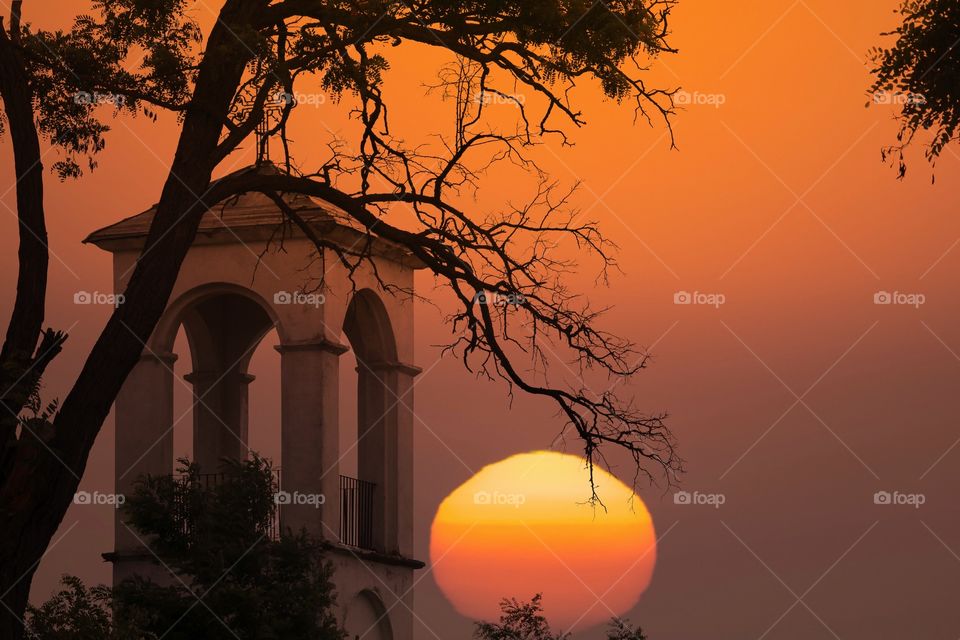 Orange sun and church tower