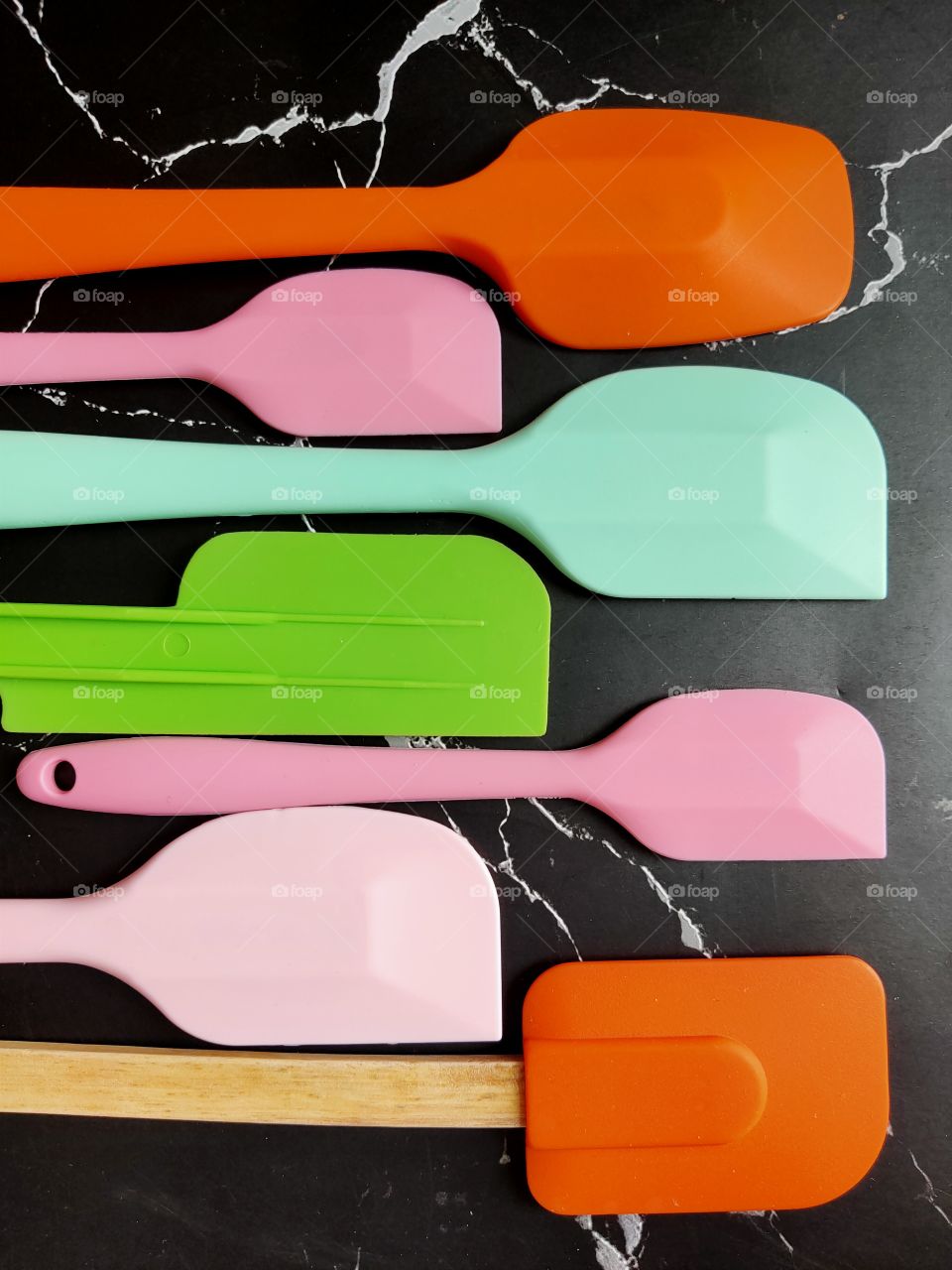 Multi-colored silicone spatula in various sizes for bakery work.