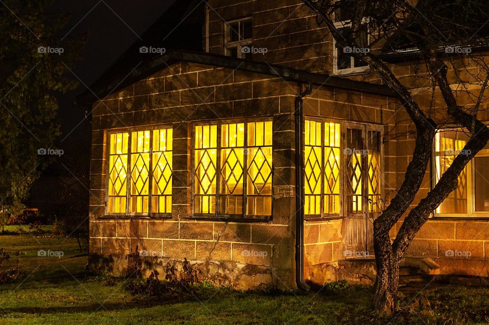 Residental house at night with warm light in the windows