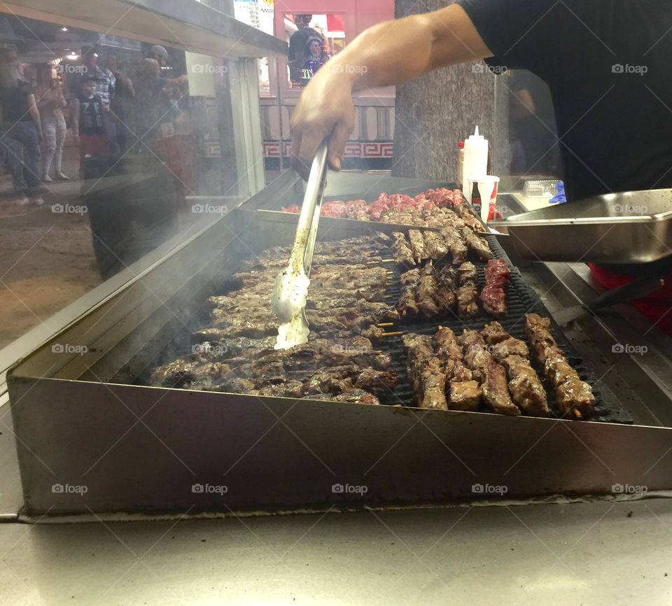 Steak kabobs being grilled by a street vendor