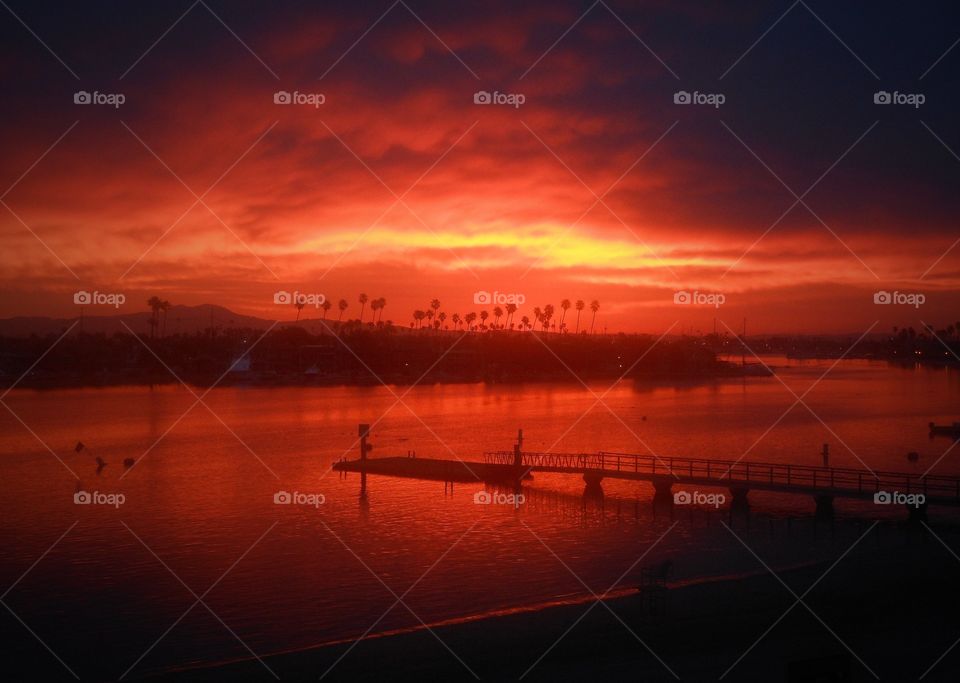 Red orange sunset over bay