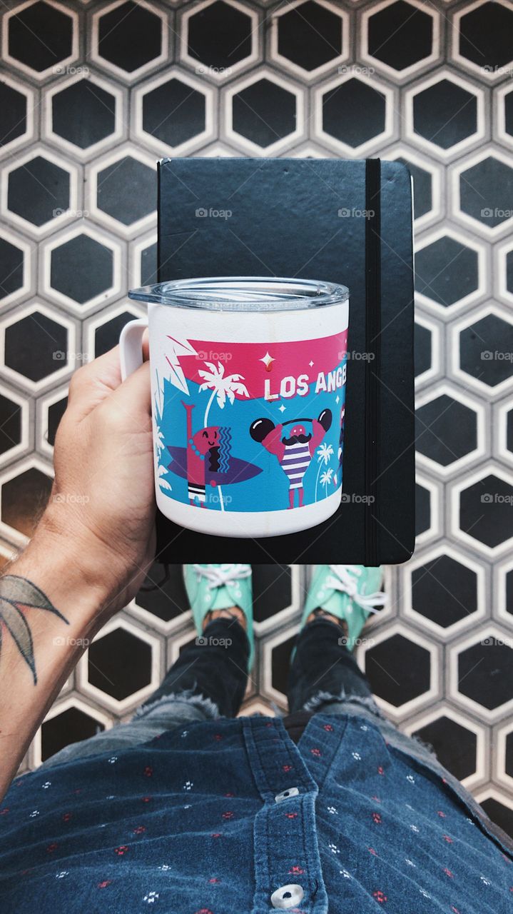 standing on a cool tile floor holding a coffee mug. 