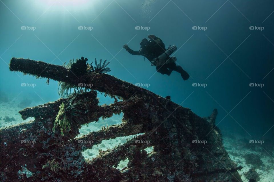 Diver flying over a shipwreck 