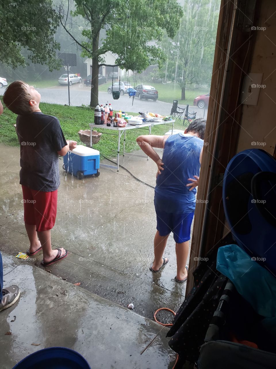 two boys playing in the rain