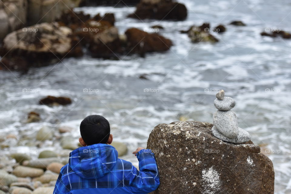 Tourist watching waves on the beach.