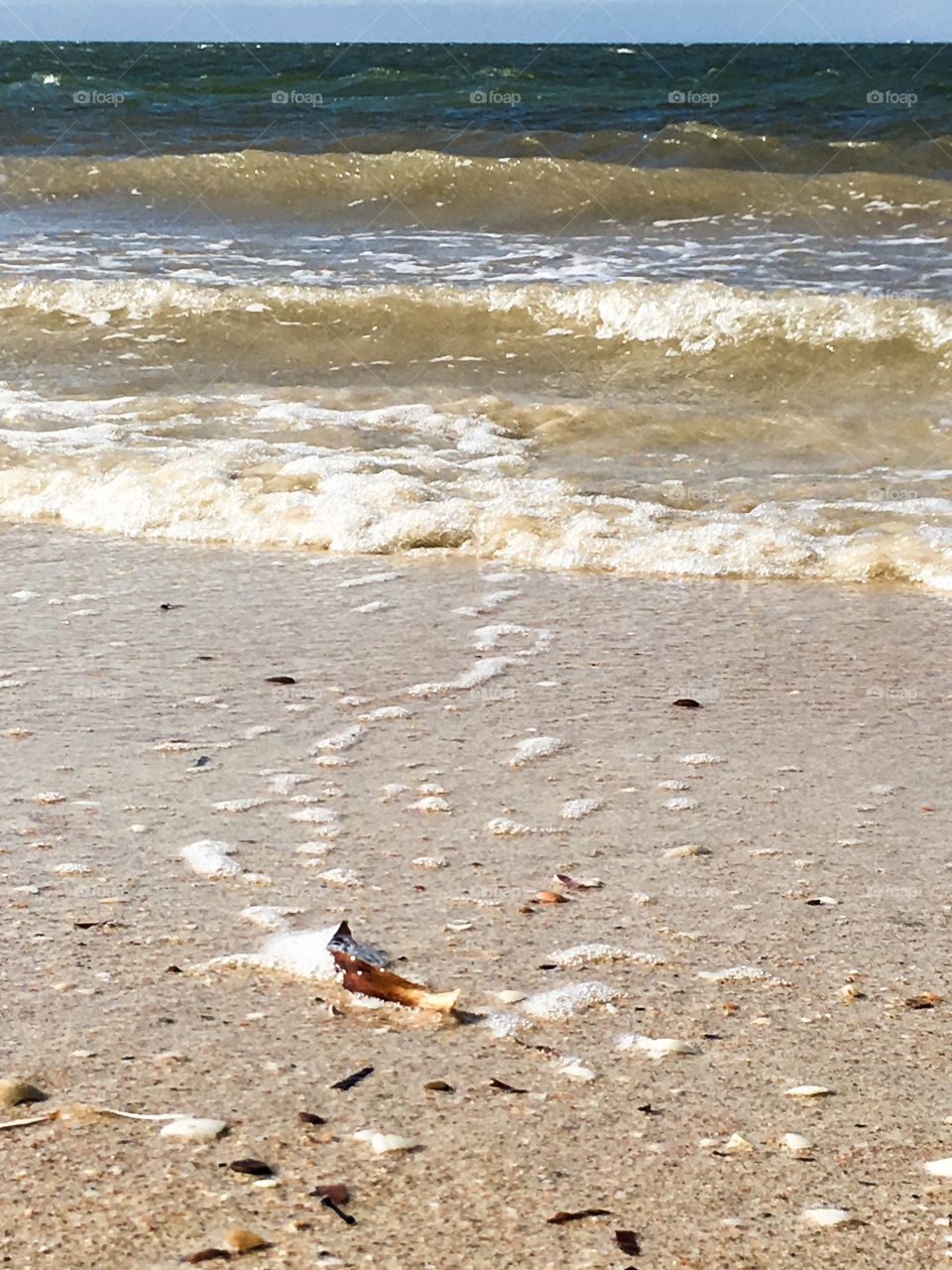 Gentle surf on south Australian beach, perspective angle sand waves and sky