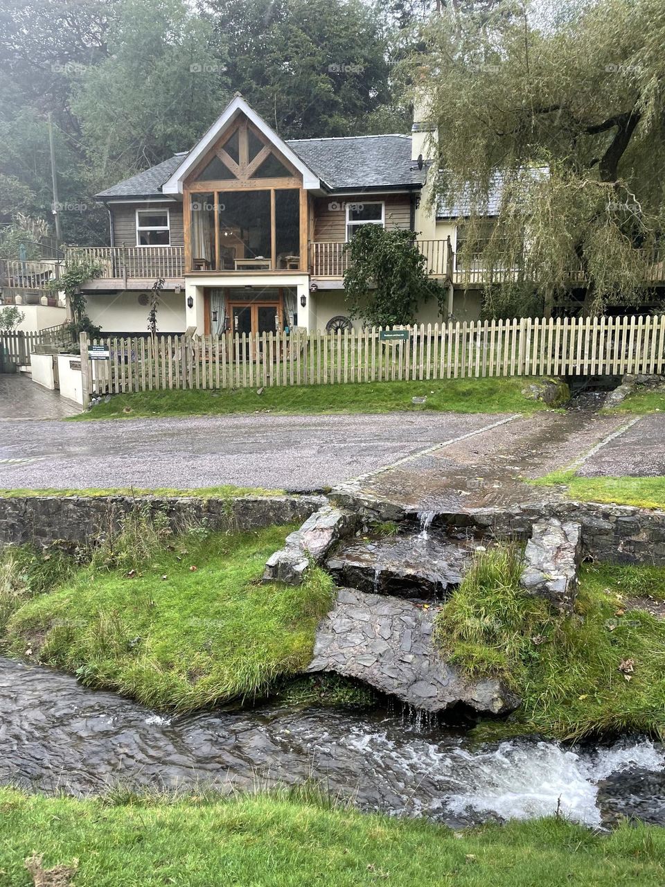 Lovely house next to a little stream snapped in the October rain 