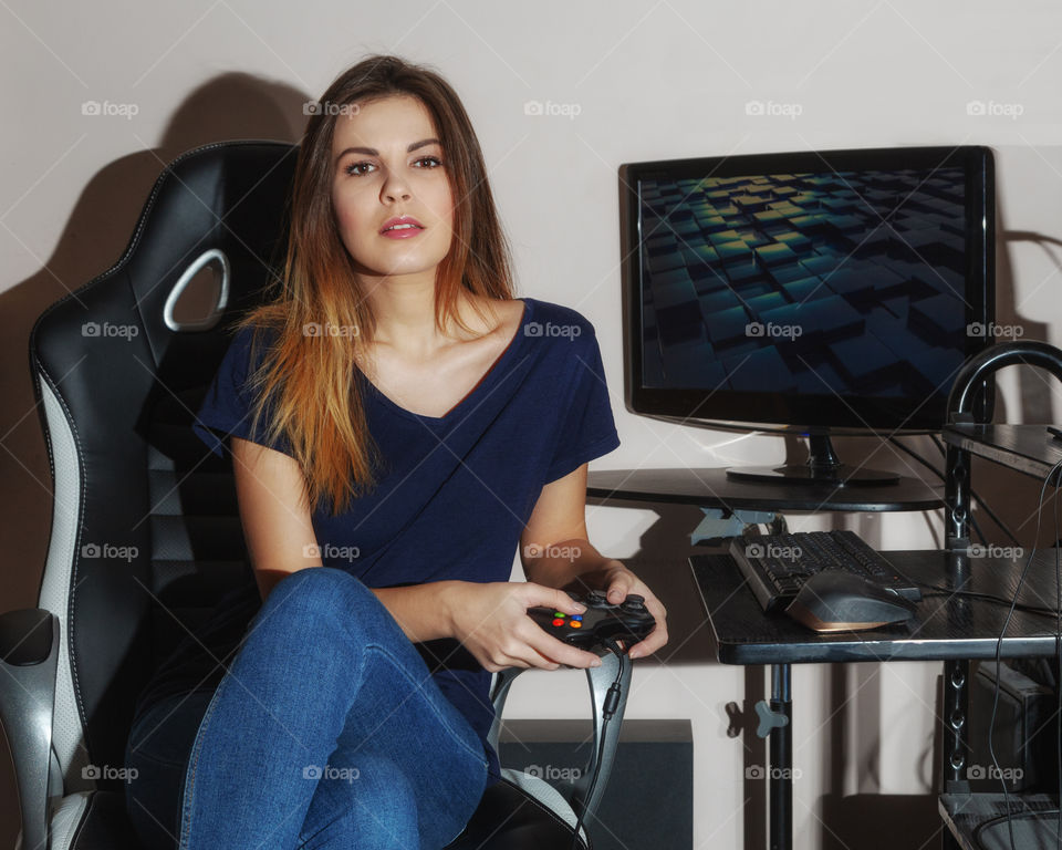 A pretty girl with a game controller in hand