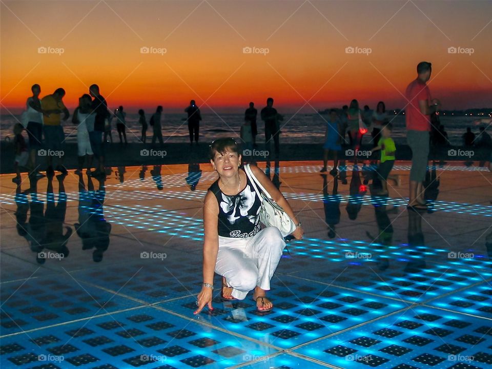 Silhouettes and shadows with beautiful sunset at Monument to the Sun in Zadar, Croatia