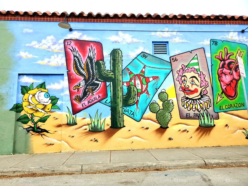 A mural on the side of a building of a popular game called Loteria, a Mexican themed bingo game.