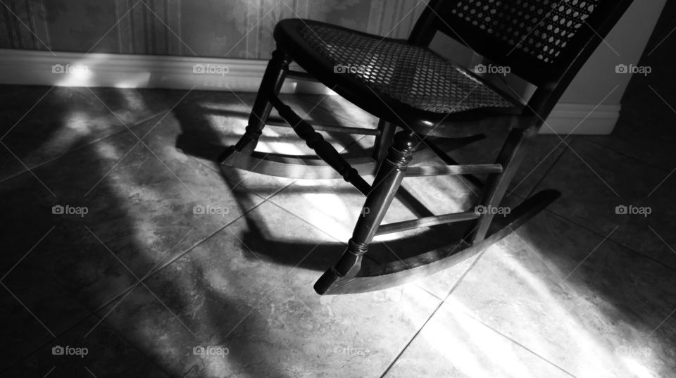 Wonderful Light Shines Onto A Wicker Rocking Chair And Tile. Black And White Photo With Selective Focus.