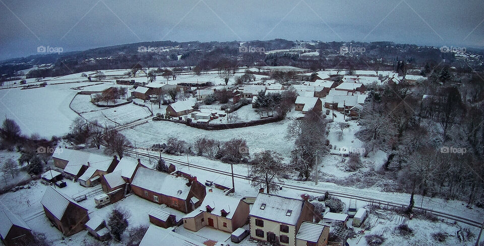 Drone image above a snowy, rural France.