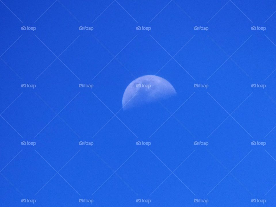 beautiful photo of the moon, blue sky in the afternoon.