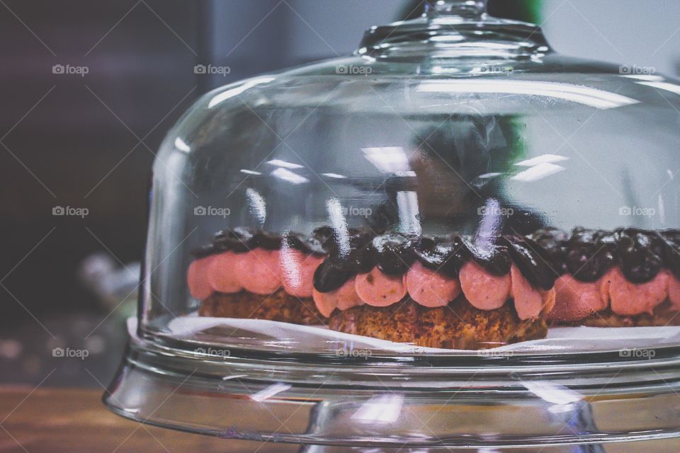 Pink and chocolate frosted donuts on display 
