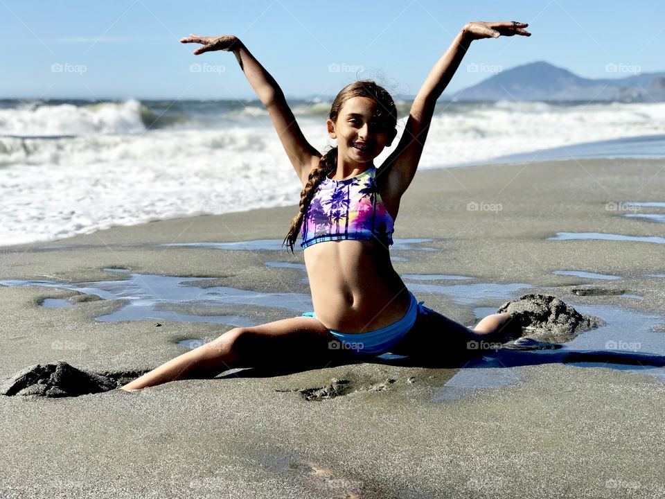 My daughter Ashley doing the splits on the sand of Gold Beach, OR.