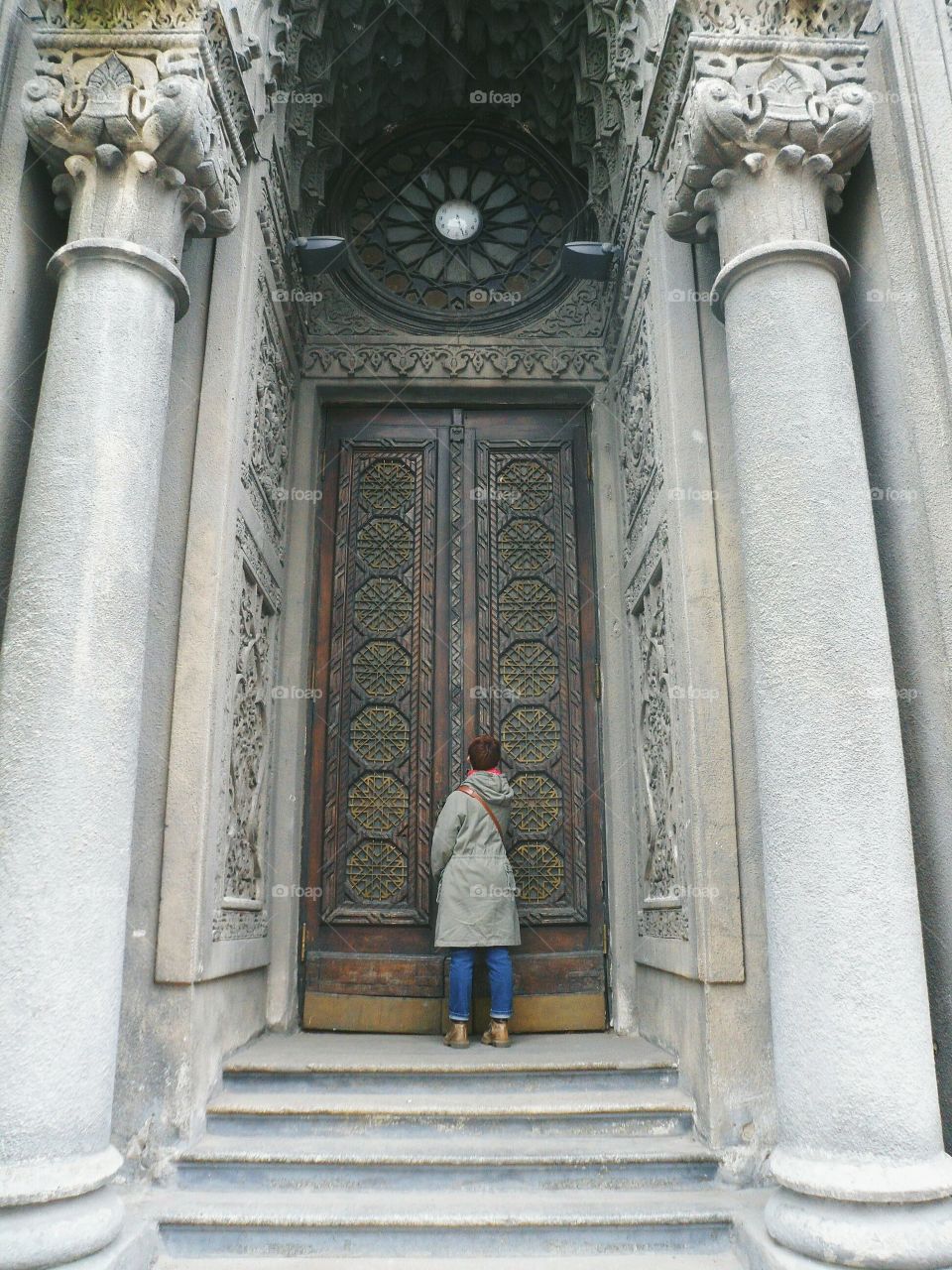 girl stands near the big doors